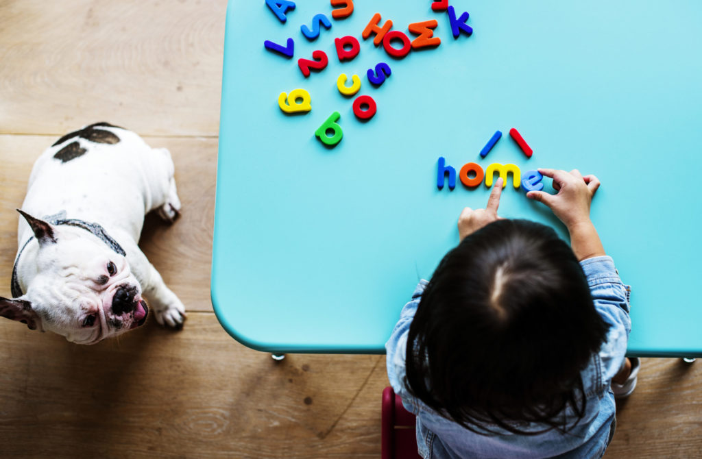 kid playing with letter toys