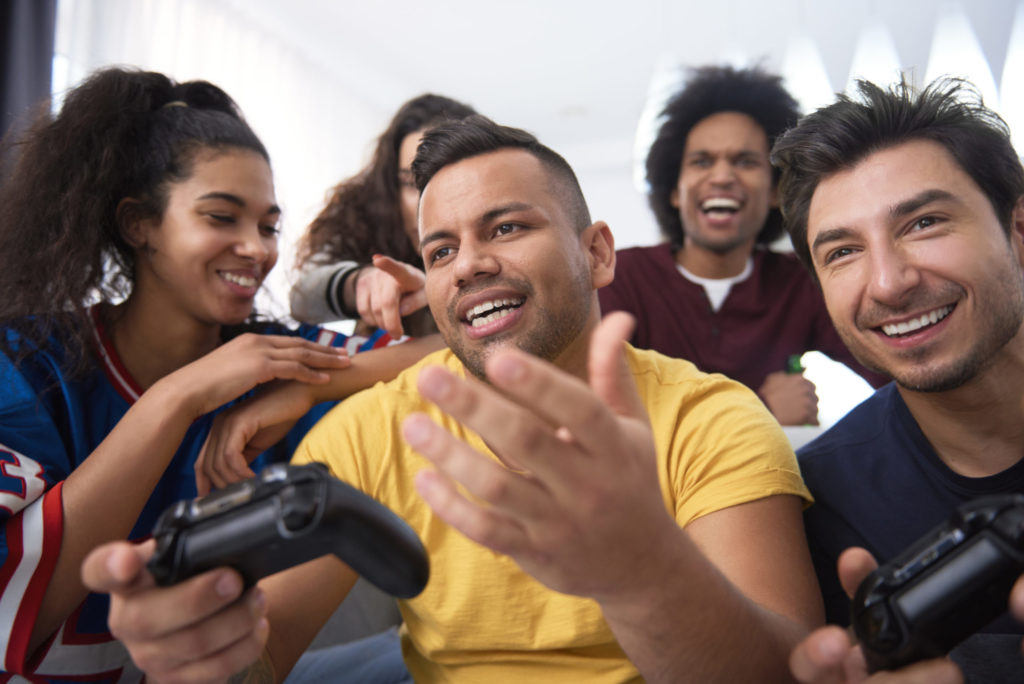 Best friends playing a game console